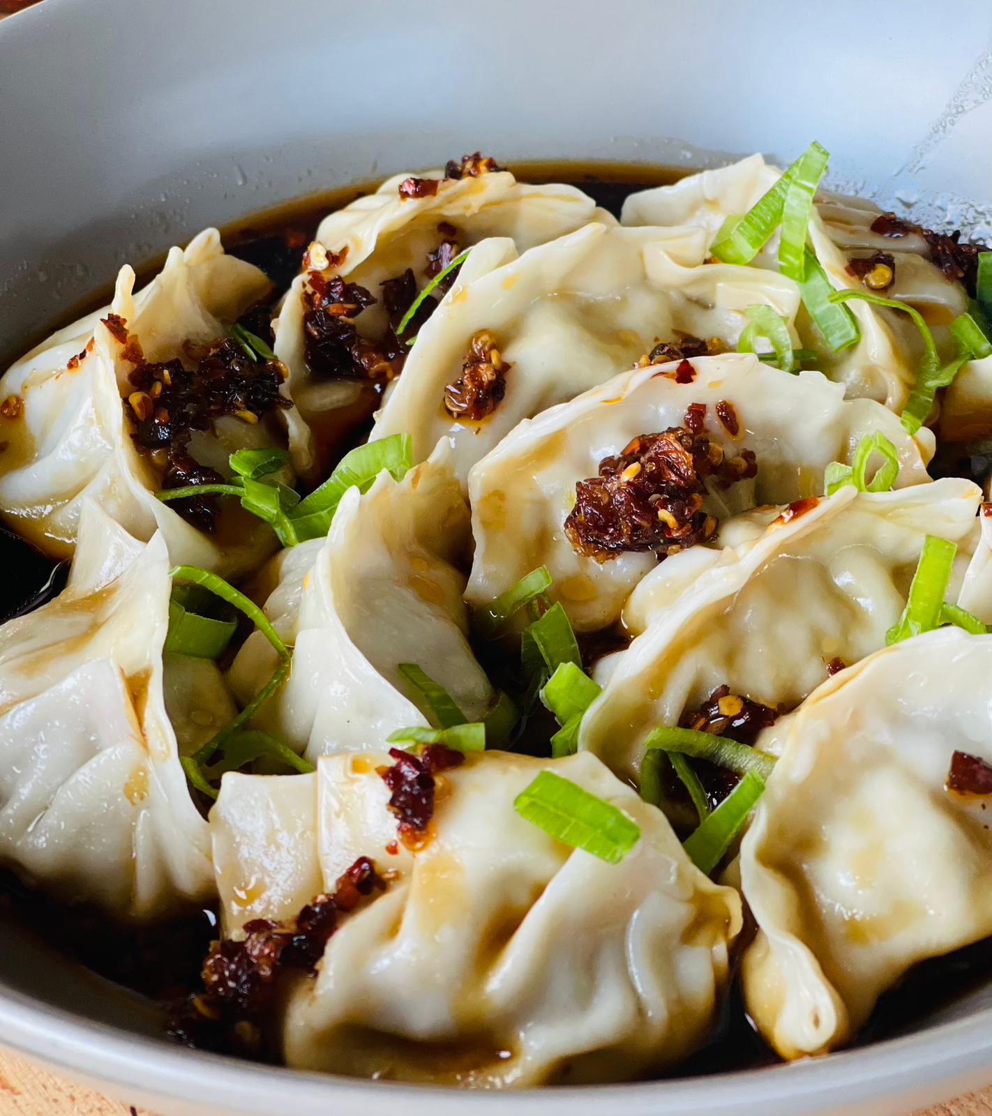 Ivy's Chilli oil over dumplings with shallots