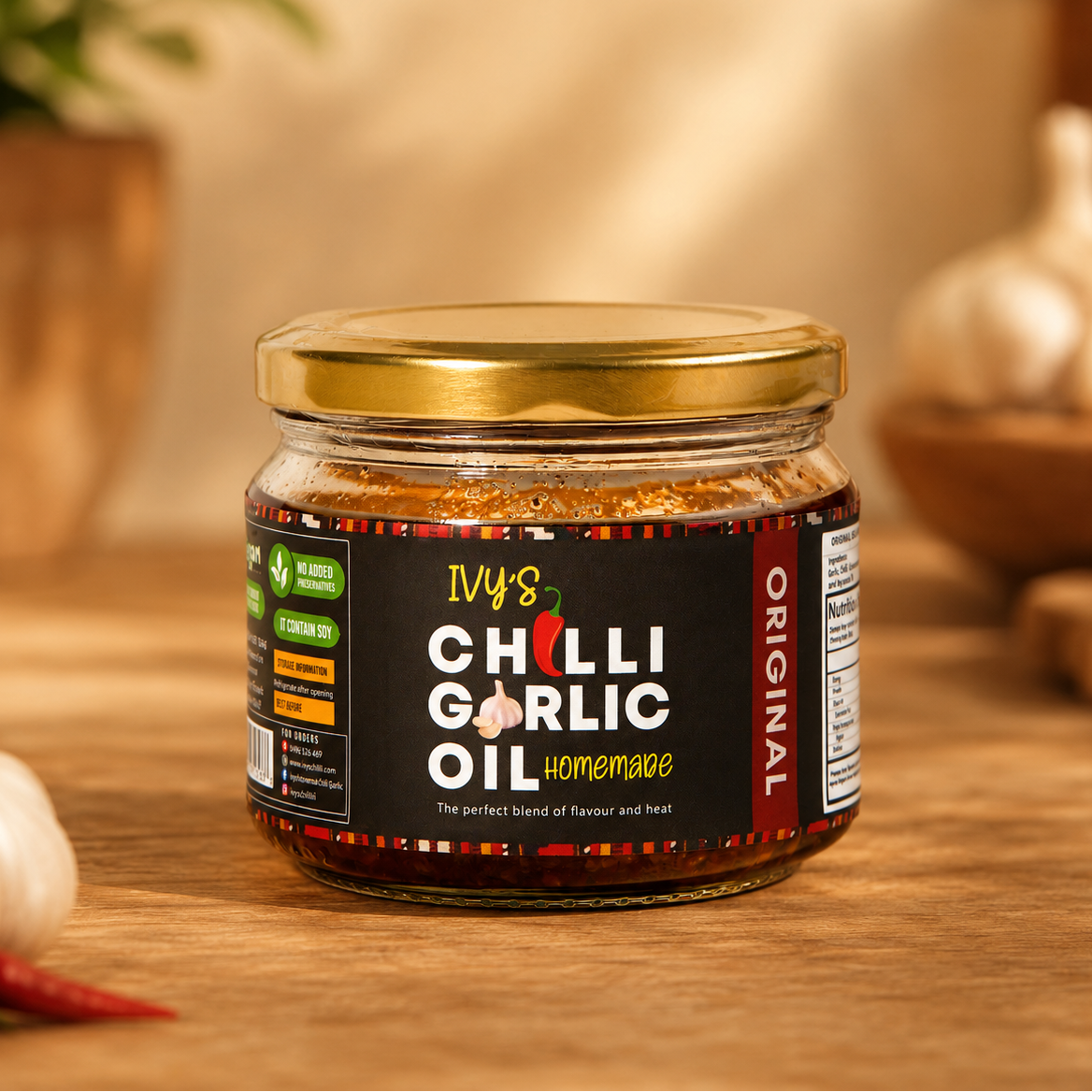Jar of IVY's Chilli Garlic Oil on a wooden surface with garlic and chili peppers in the background.